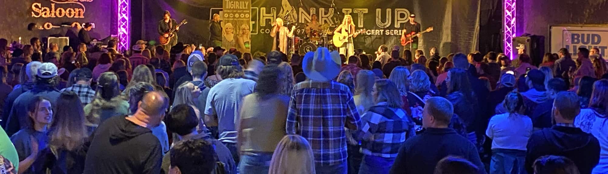 country concert with fans wearing cowboy hats Greenville