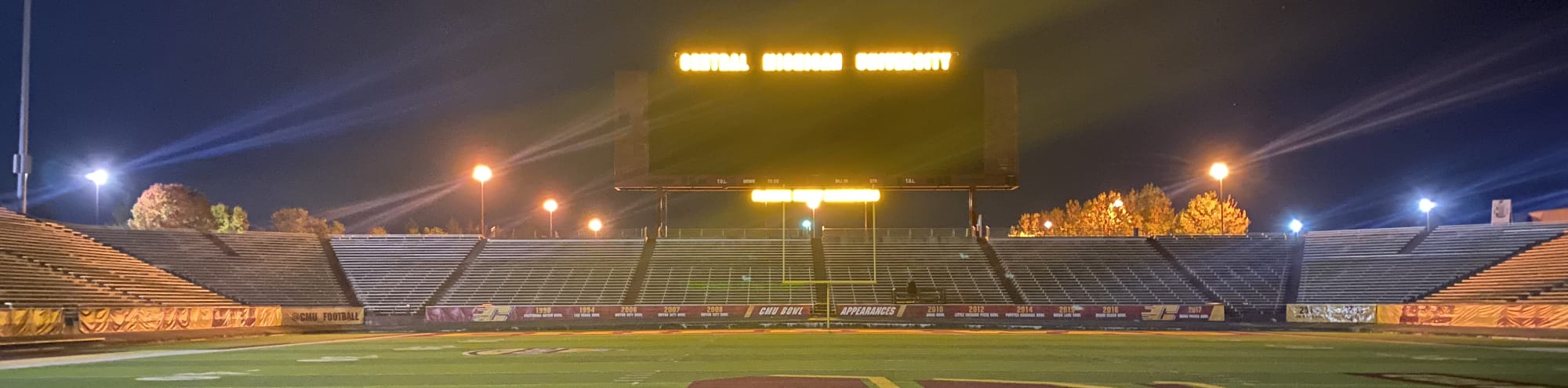 empty football stadium at night under the lights Greenville